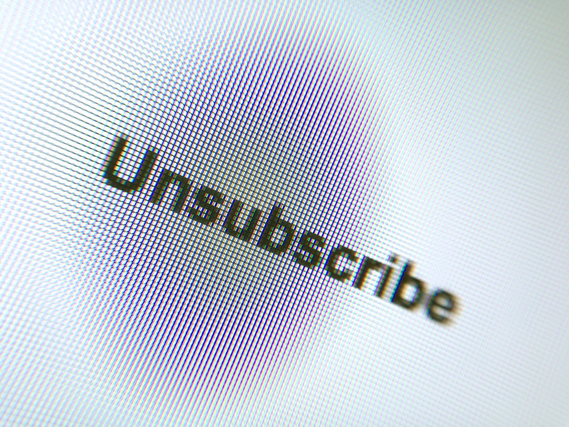 Close-Up Of Unsubscribe Text And Thumbprint On Device Screen